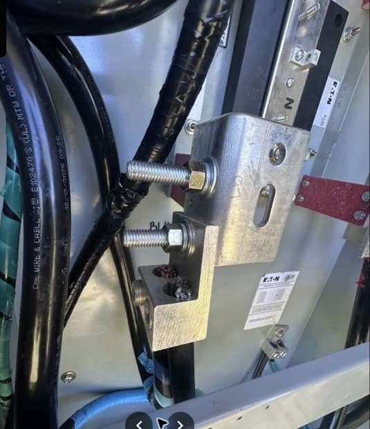 Close detail of high-power electrical panel hardware and wiring.