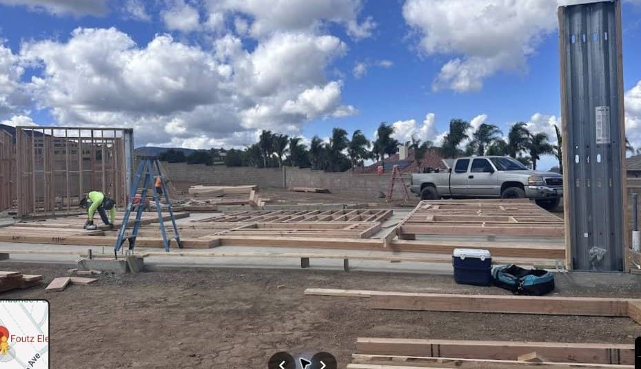 New construction site with electrical service equipment being prepared.