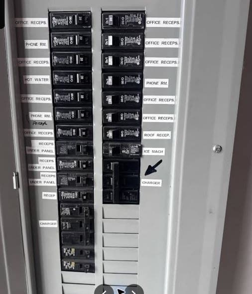Labeled breaker panel with office and charger circuits.